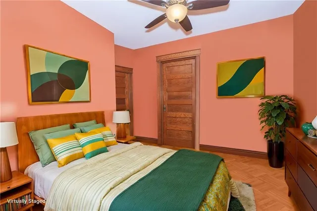 a bedroom with a bed and a painting on the wall