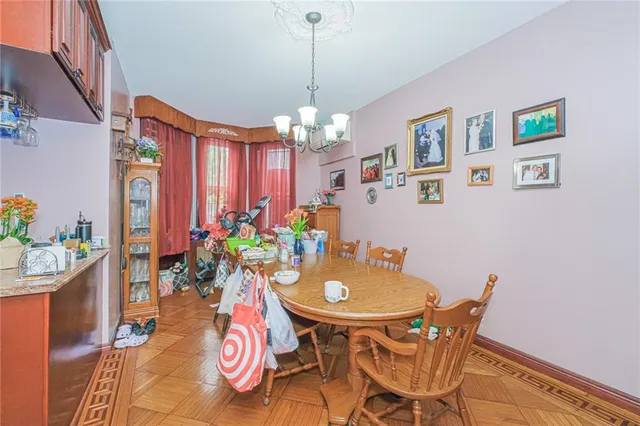 a view of a dining room with furniture and chandelier