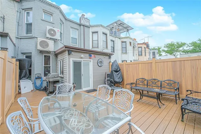 a view of a patio with table and chairs with wooden floor