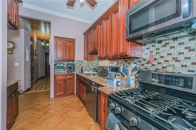 a kitchen with stainless steel appliances granite countertop a stove and a sink