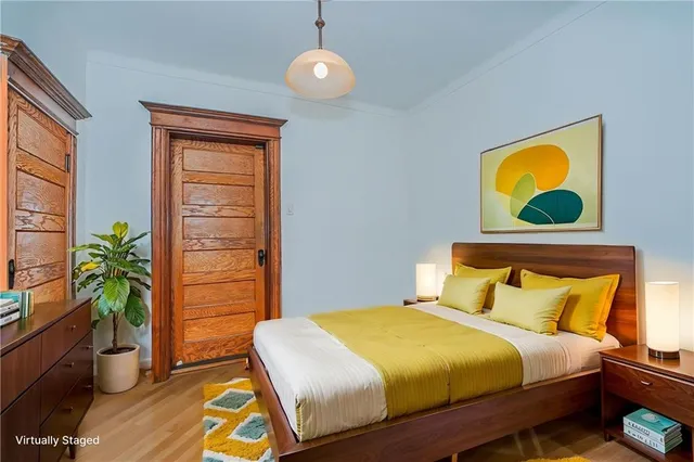 a bedroom with a bed and a potted plant