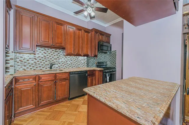 a kitchen with stainless steel appliances granite countertop a sink and cabinets