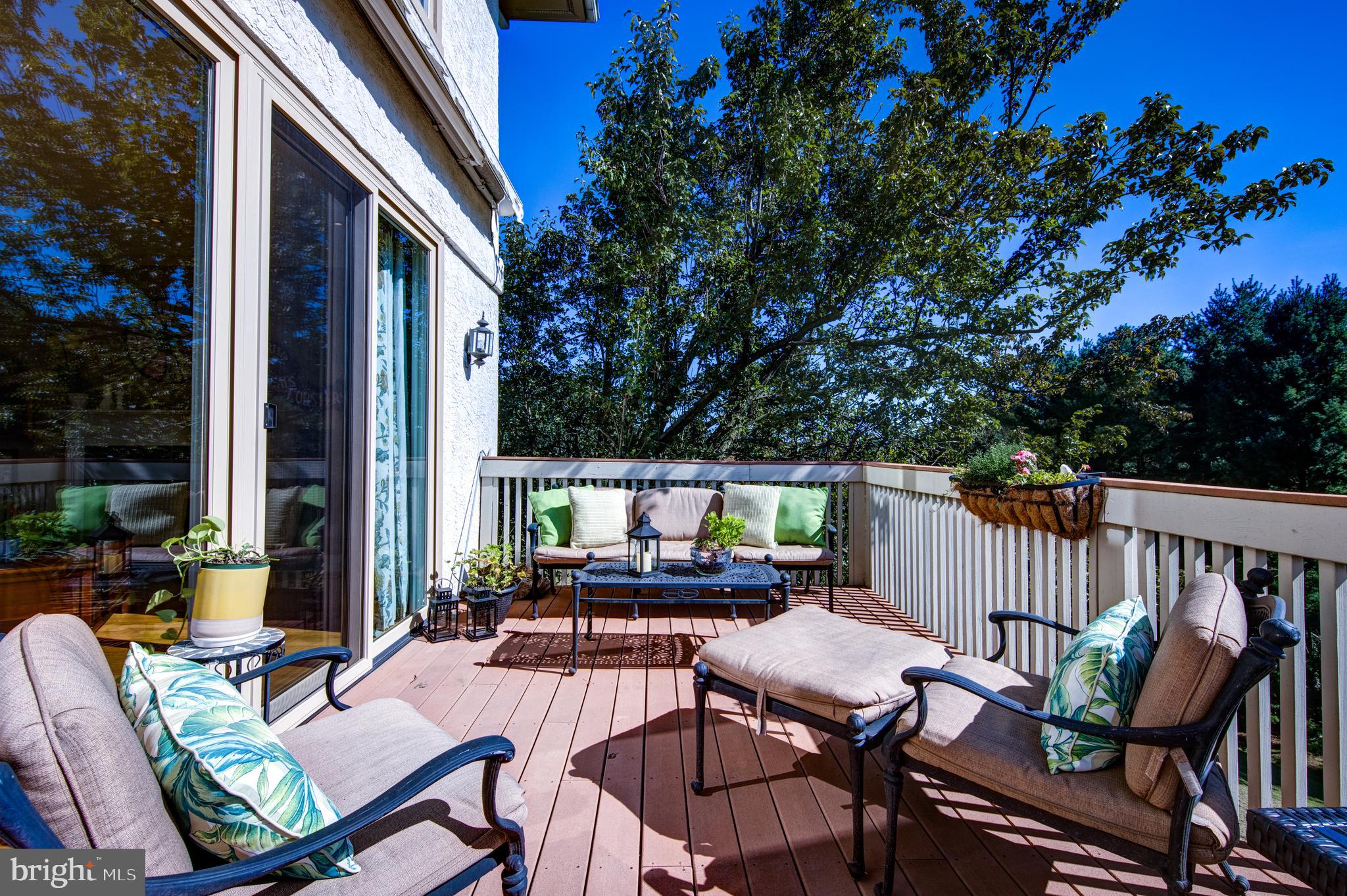 242 Ravenscliff Road Wayne, PA 19087 - Photo 13 of 49 a view of a patio with a table chairs and a flower garden