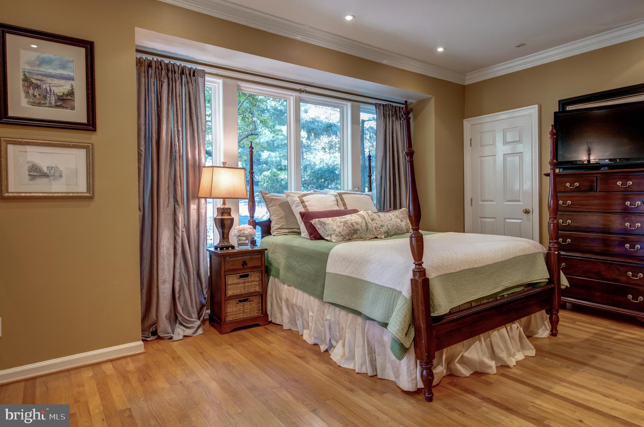 242 Ravenscliff Road Wayne, PA 19087 - Photo 16 of 49 a bedroom with a bed and a flat tv screen on dresser