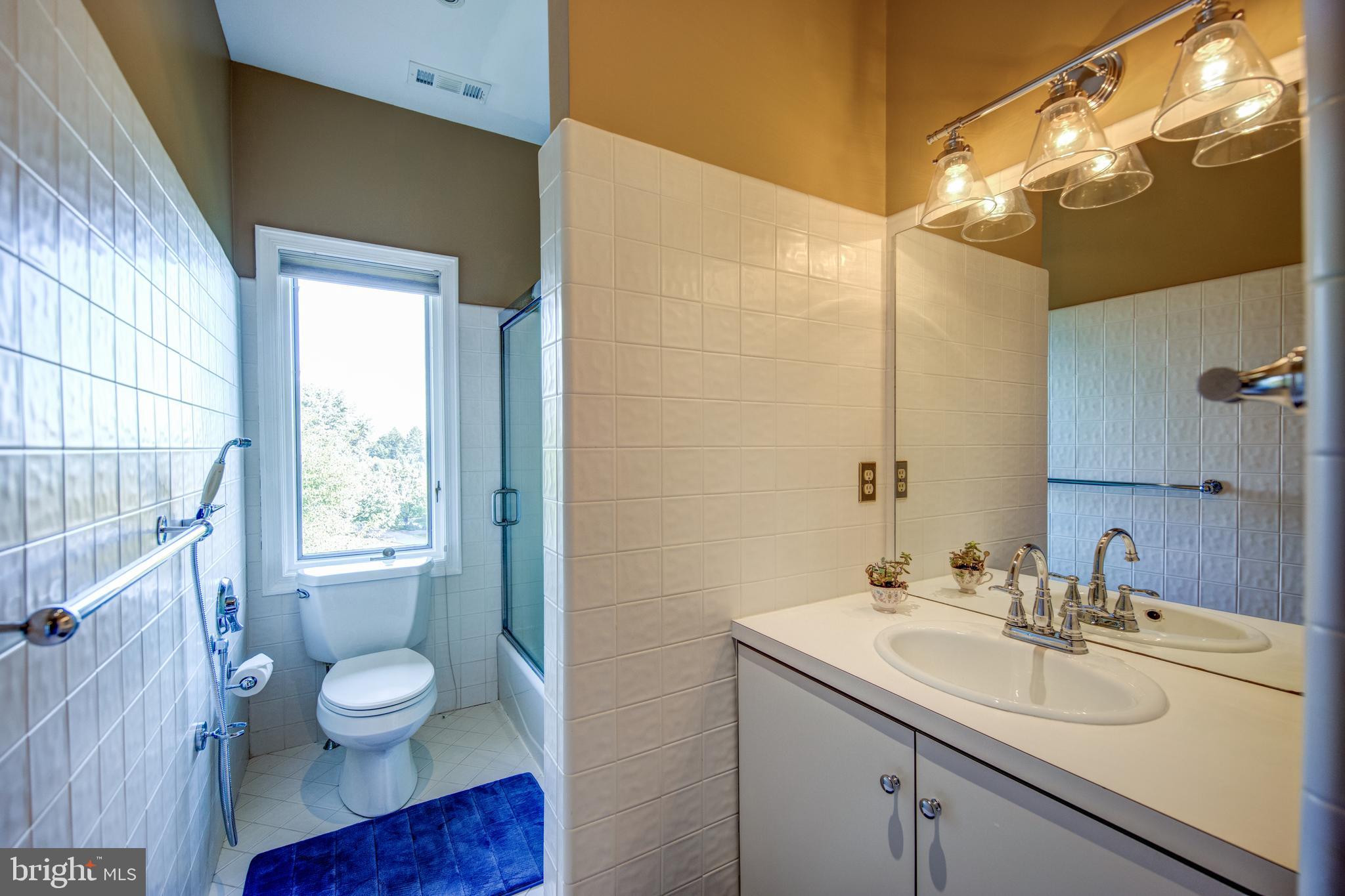 242 Ravenscliff Road Wayne, PA 19087 - Photo 31 of 49 a bathroom with a granite countertop sink toilet and a mirror
