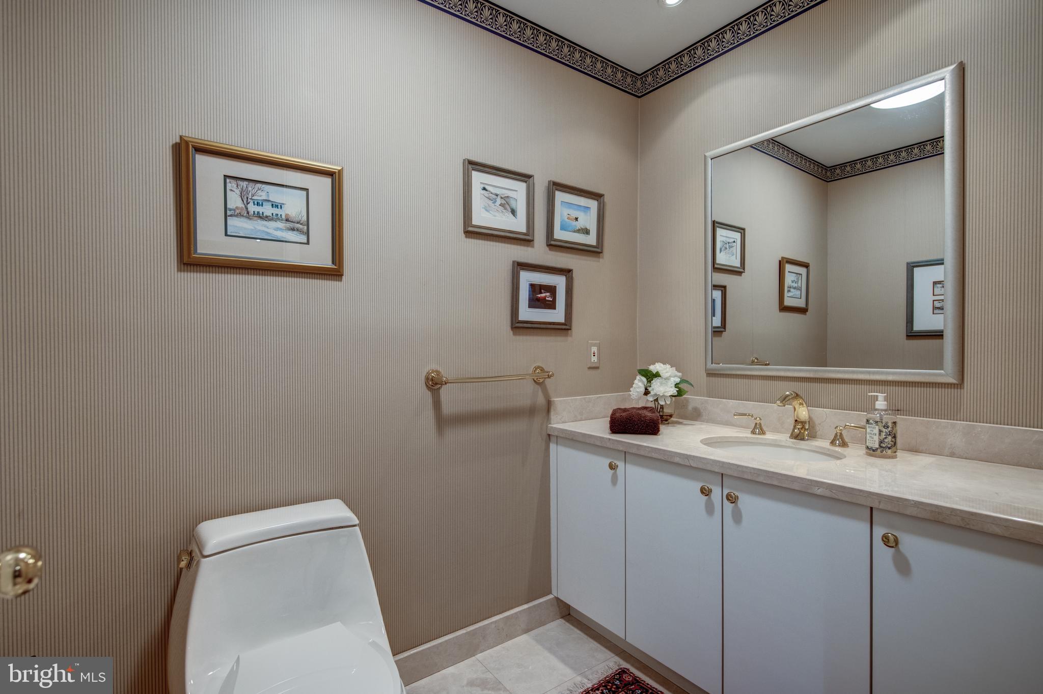 242 Ravenscliff Road Wayne, PA 19087 - Photo 36 of 49 a bathroom with a toilet sink and mirror