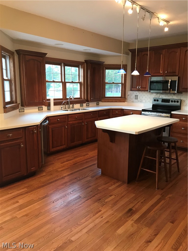 8770 North Kane Road Wadsworth, OH 44281 - Photo 9 of 29 Extensive cabinetry, (Cherry) breakfast bar, Stainless appliances, solid surface counter tops
. The kitchen flows into the family room. Open the slider and the deck is there to enjoy your outdoors.