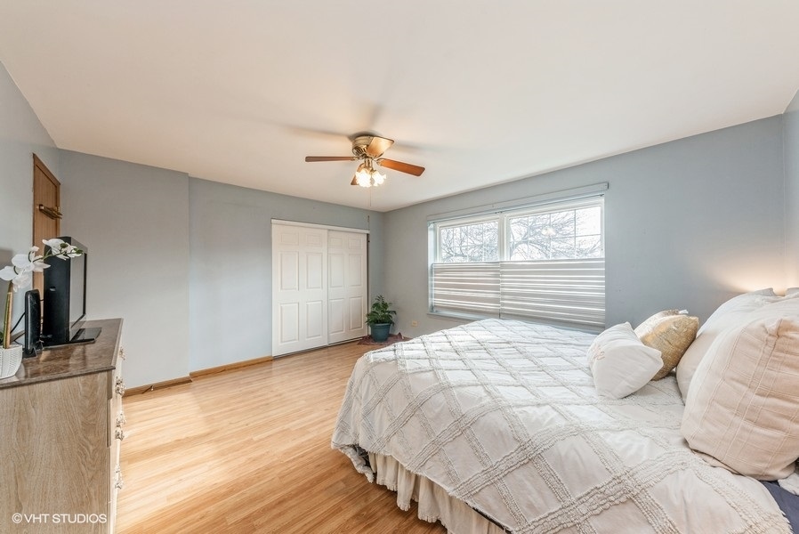 4539 Opal Drive Hoffman Estates, IL 60192 - Photo 11 of 27 a bedroom with a bed and a window