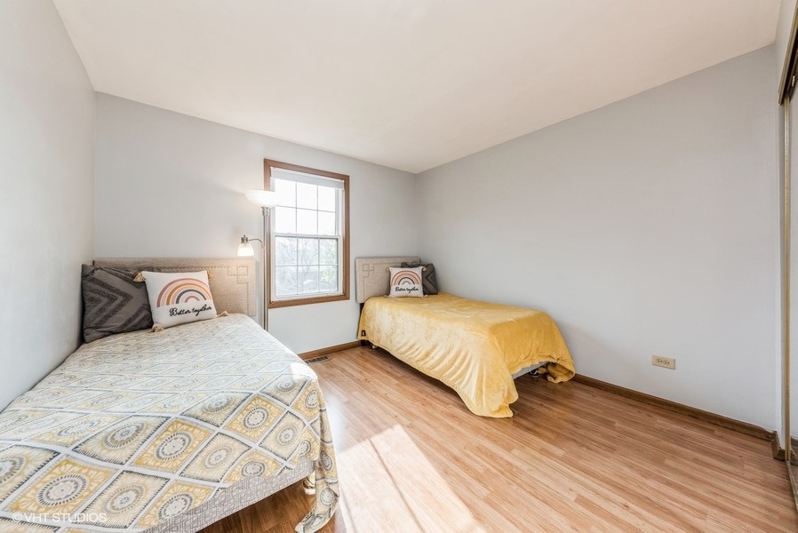 4539 Opal Drive Hoffman Estates, IL 60192 - Photo 15 of 27 a bedroom with a bed and wooden floor