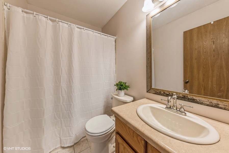 4539 Opal Drive Hoffman Estates, IL 60192 - Photo 16 of 27 a bathroom with a sink toilet and a mirror