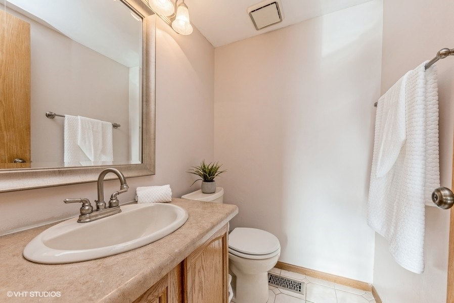 4539 Opal Drive Hoffman Estates, IL 60192 - Photo 19 of 27 a bathroom with a sink toilet and shower