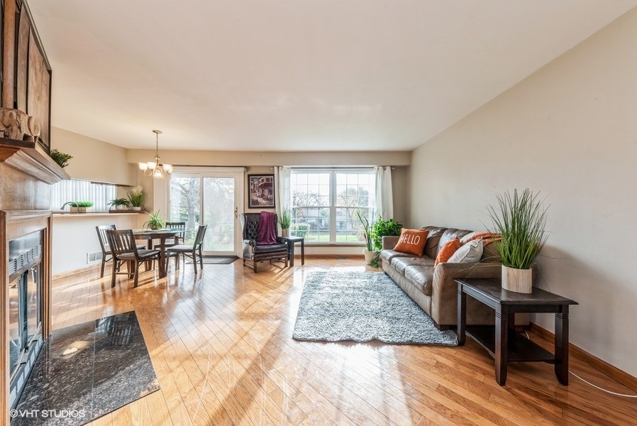 4539 Opal Drive Hoffman Estates, IL 60192 - Photo 2 of 27 a living room with furniture wooden floor and a table