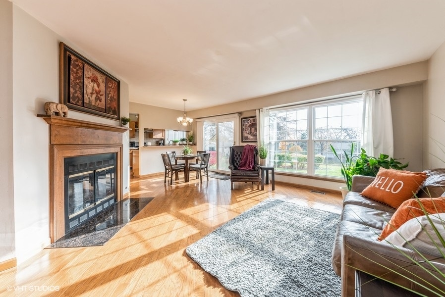 4539 Opal Drive Hoffman Estates, IL 60192 - Photo 3 of 27 a living room with furniture and a fireplace