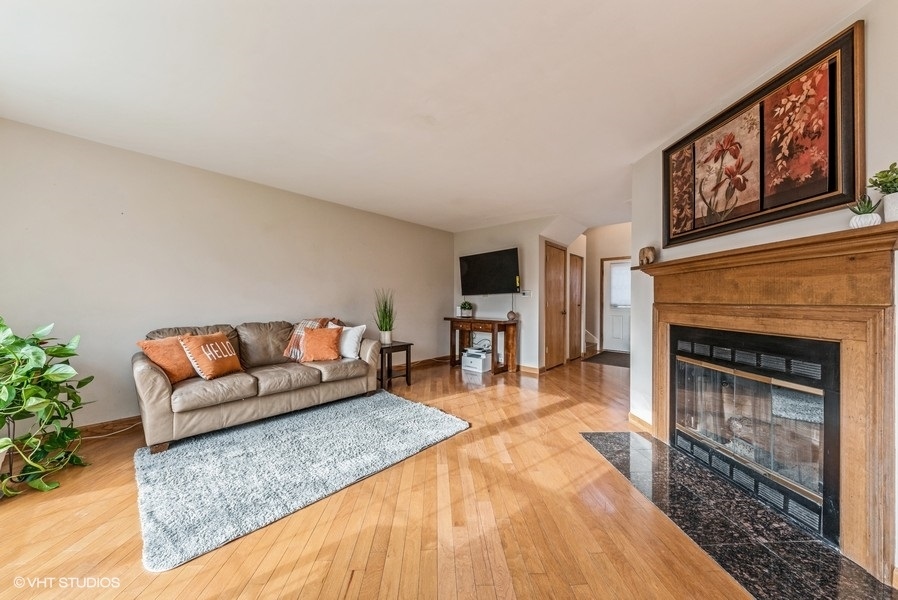4539 Opal Drive Hoffman Estates, IL 60192 - Photo 4 of 27 a living room with furniture and a fireplace