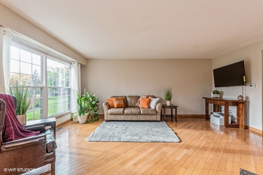 4539 Opal Drive Hoffman Estates, IL 60192 - Photo 5 of 27 a living room with furniture and a flat screen tv