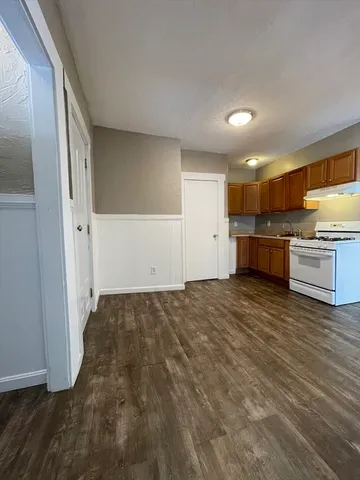 a view of a kitchen with a sink and a refrigerator