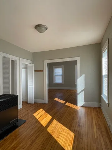 a view of a room with wooden floor and window