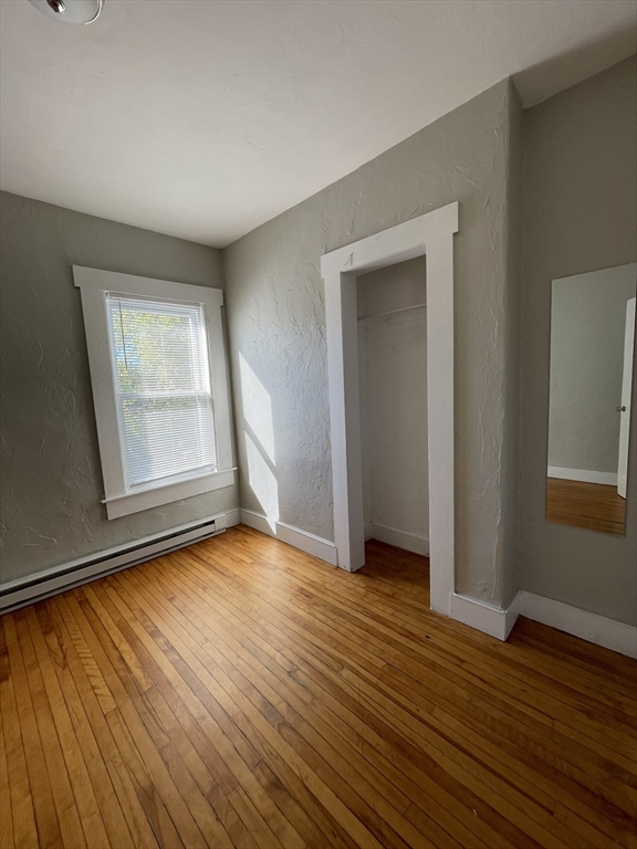 5 Freeland Terrace, Unit 3 Worcester, MA 01603 - Photo 20 of 25 a view of an empty room with wooden floor and a window