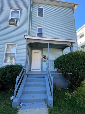 a front view of a house with stairs