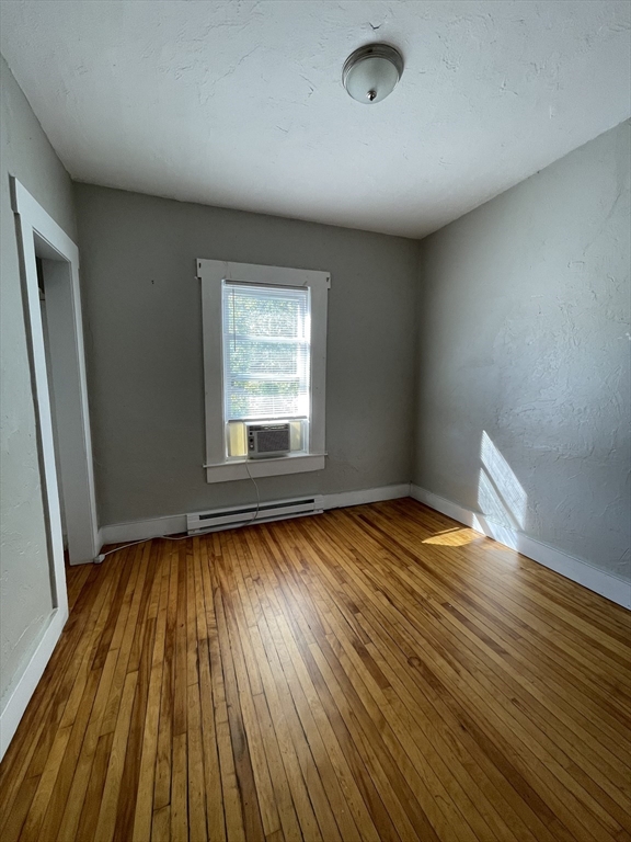 5 Freeland Terrace, Unit 3 Worcester, MA 01603 - Photo 21 of 25 an empty room with wooden floor and windows