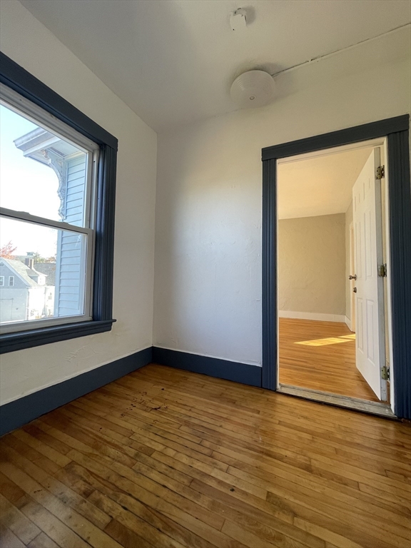5 Freeland Terrace, Unit 3 Worcester, MA 01603 - Photo 24 of 25 a view of an empty room with wooden floor and a window