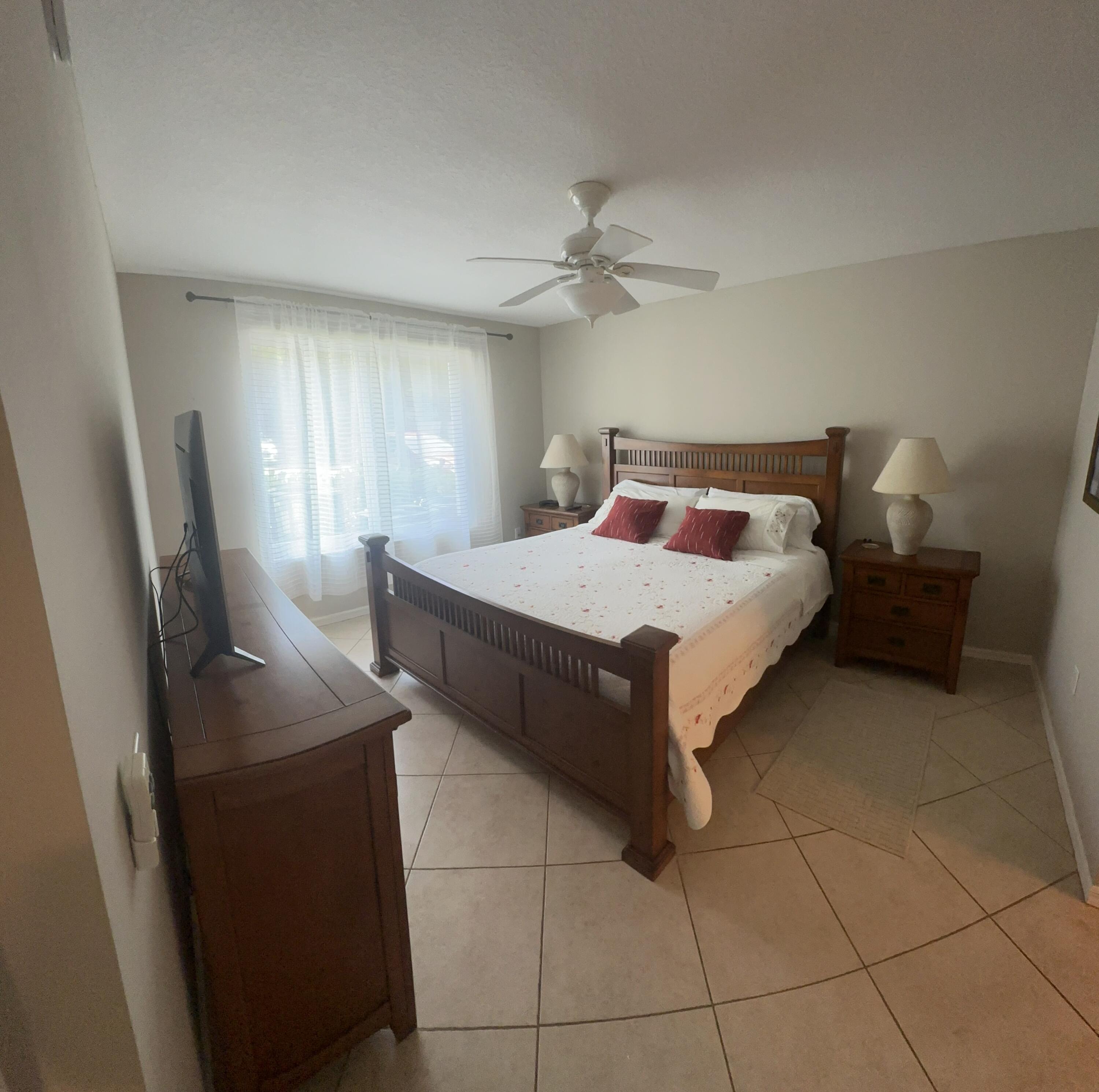 805 Villa Circle Boynton Beach, FL 33435 - Photo 11 of 21 a spacious bedroom with a bed and window