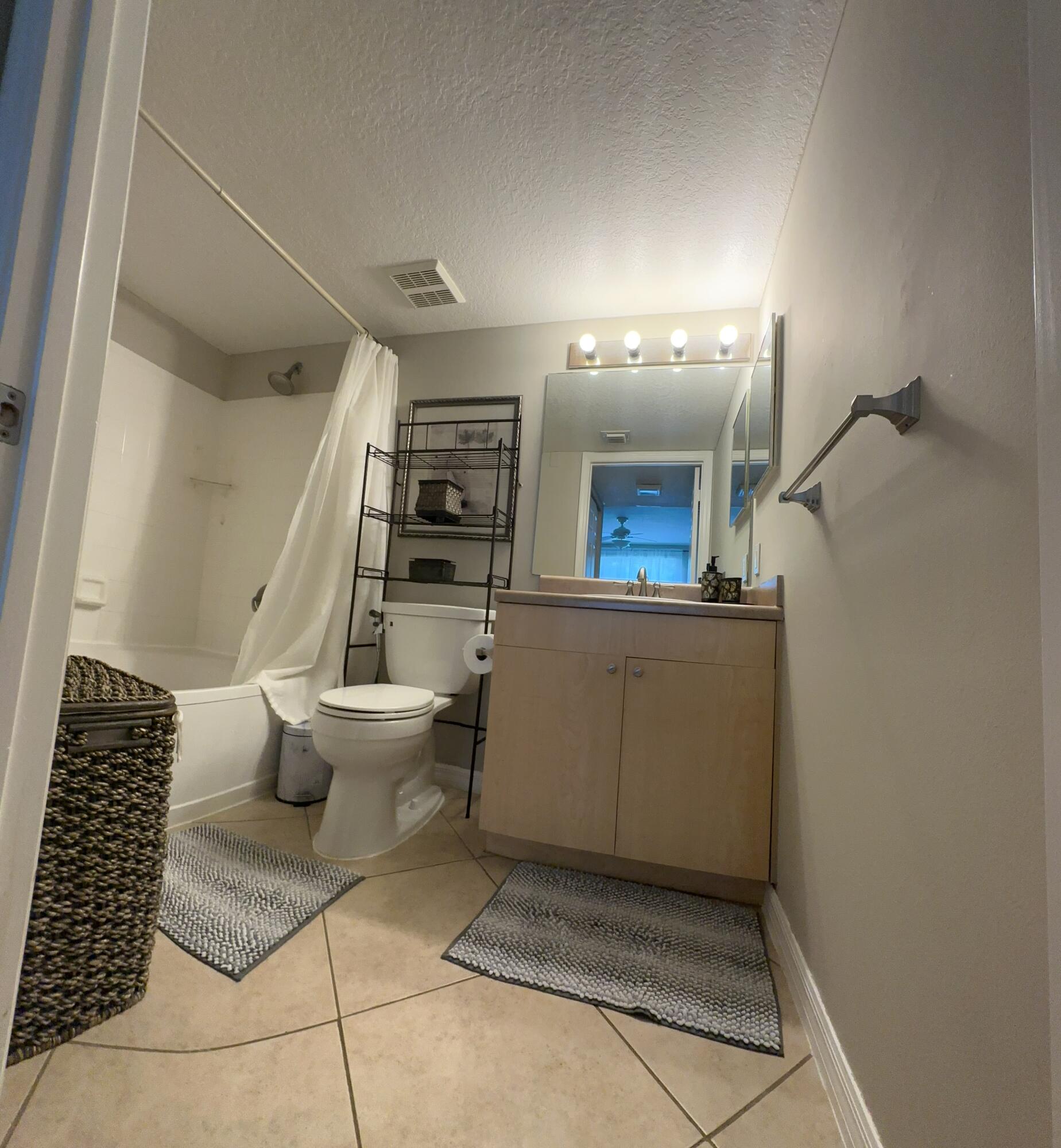 805 Villa Circle Boynton Beach, FL 33435 - Photo 9 of 21 a bathroom with a toilet sink and mirror