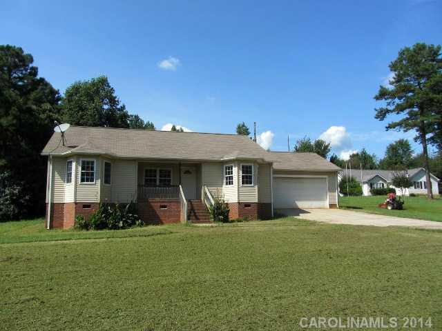 300 Sutton Spring Road York, SC 29745 - Photo 1 of 12 a front view of a house with a garden and yard