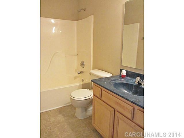 300 Sutton Spring Road York, SC 29745 - Photo 7 of 12 a bathroom with a granite countertop sink a toilet and shower