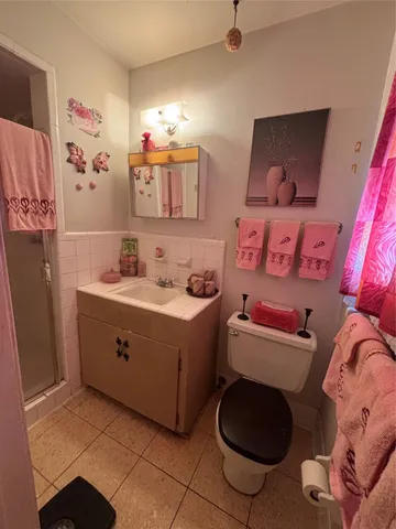 a room with a baby bed a couch and dresser