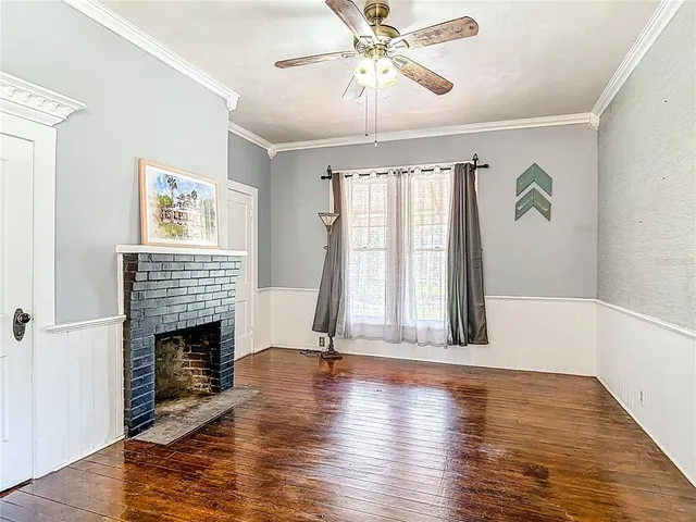 a view of livingroom with furniture wooden floor window and fireplace
