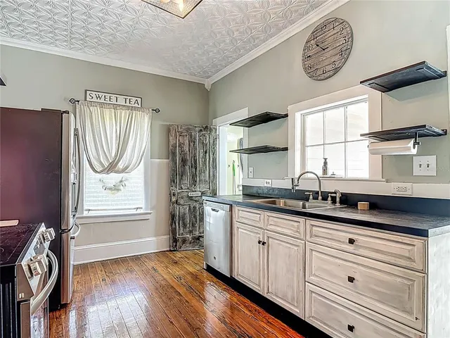a view of staircase with wooden floor and white walls