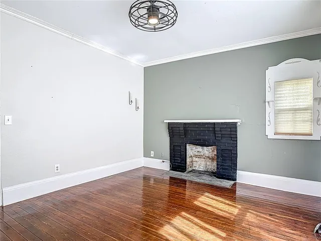a view of a livingroom with wooden floor and a ceiling fan