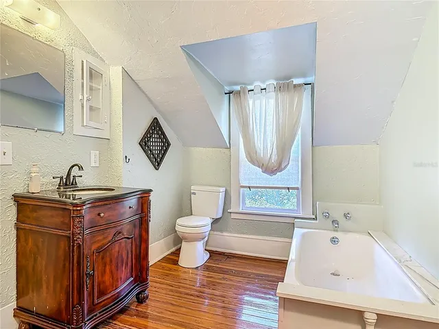 a backyard of a house with wooden floor and outdoor seating