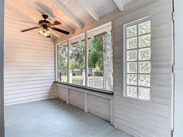an aerial view of residential house with outdoor space and trees all around