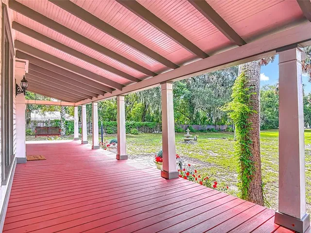 a view of a livingroom with a fireplace wooden floor and a window