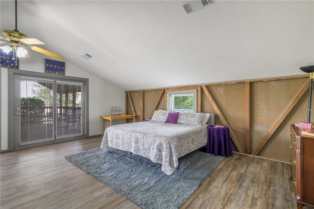 1441 Salem Road Brenham, TX 77833 - Photo 18 of 34 Bedroom with lofted ceiling, wood finished floors, and access to exterior
