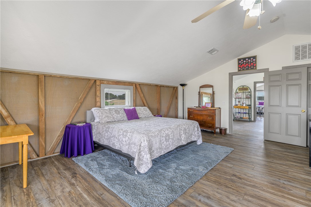 1441 Salem Road Brenham, TX 77833 - Photo 19 of 34 Bedroom featuring vaulted ceiling, wood finished floors, and a ceiling fan