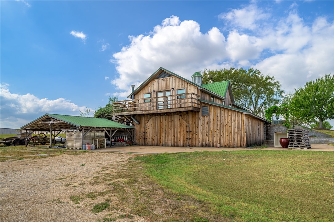 1441 Salem Road Brenham, TX 77833 - Photo 5 of 34 View of side of property featuring a yard, a metal roof, and stairway