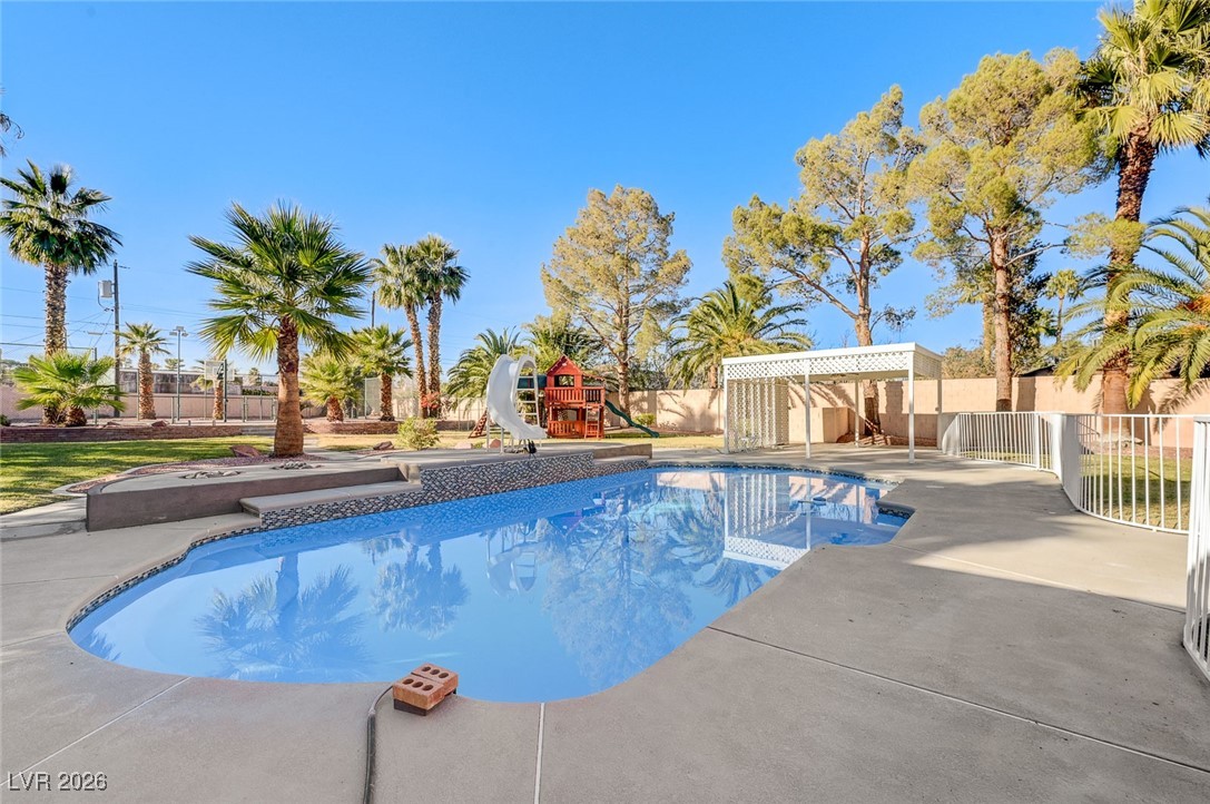 2955 El Camino Road Las Vegas, NV 89146 - Photo 4 of 99 View of pool featuring a water slide, a patio area, and a playground