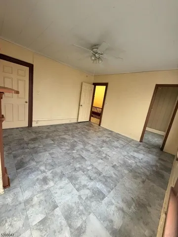 a view of empty room with a fireplace
