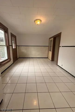 a view of a livingroom with an empty space and a window