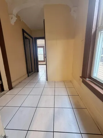 a view of an empty room and a window