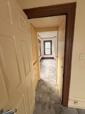a view of a hallway with wooden floor and a hallway