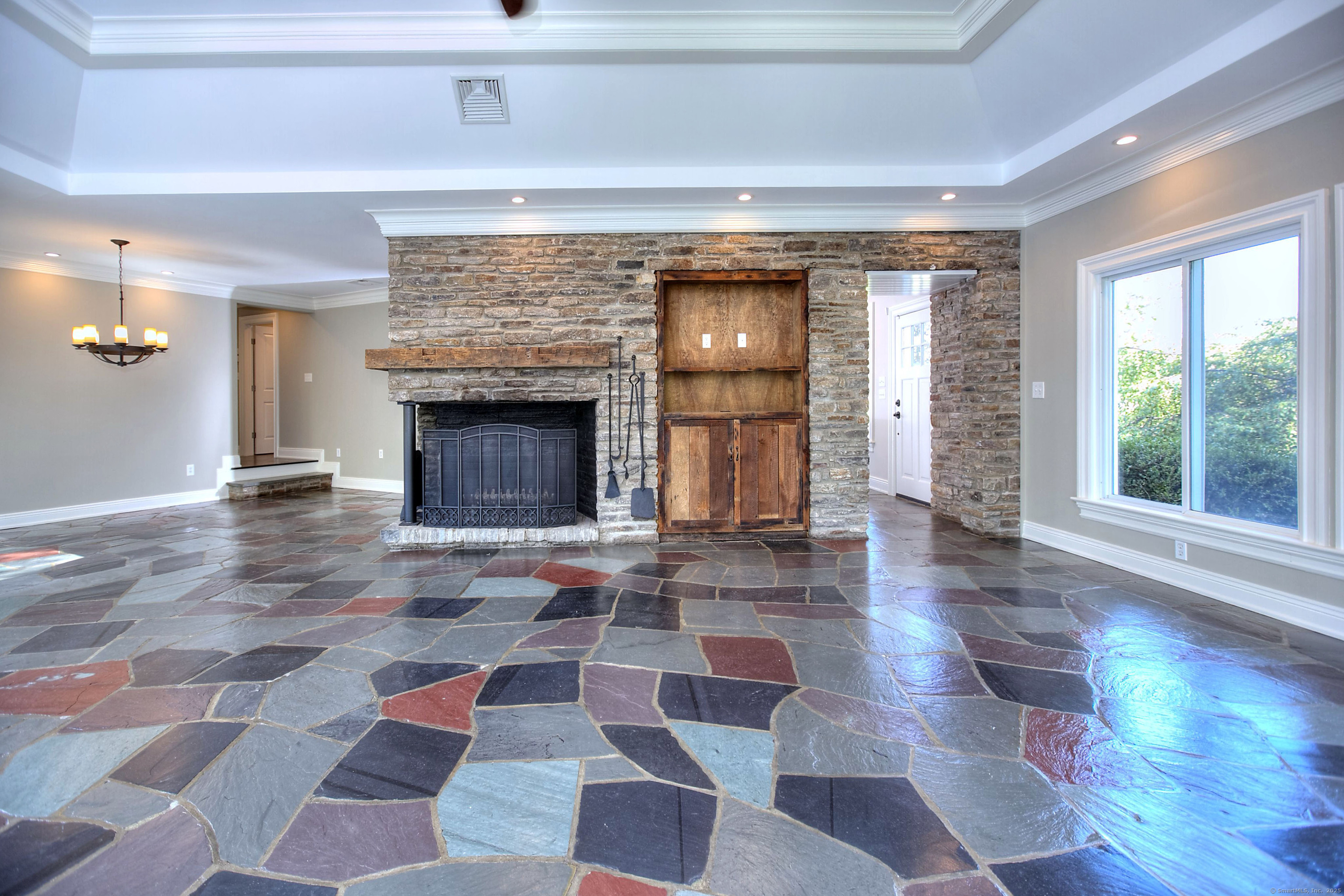27 Rogues Ridge Road Weston, CT 06883 - Photo 11 of 39 a living room with a rug and a fireplace
