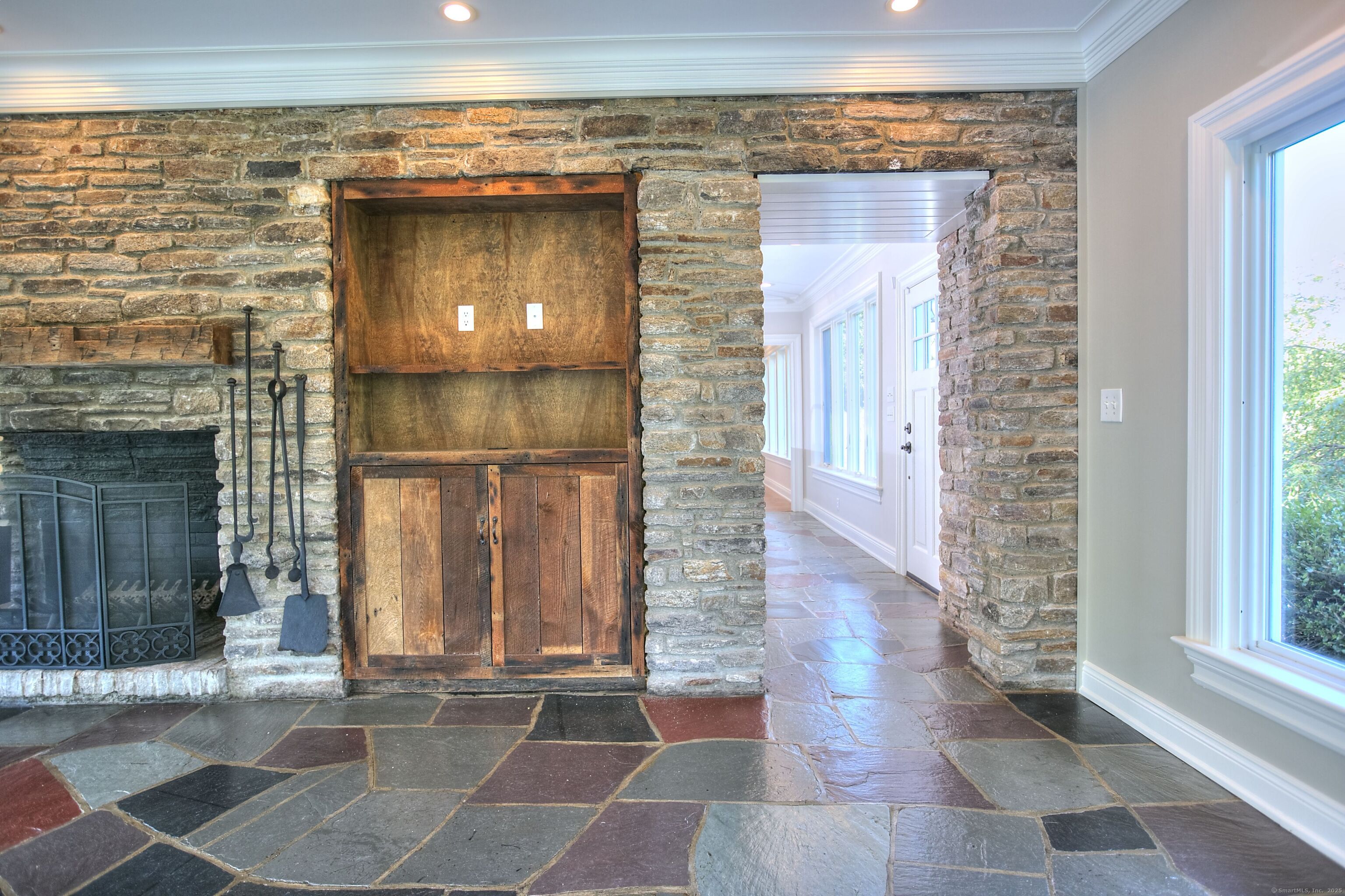 27 Rogues Ridge Road Weston, CT 06883 - Photo 14 of 39 a hallway with sliding glass door and glass windows