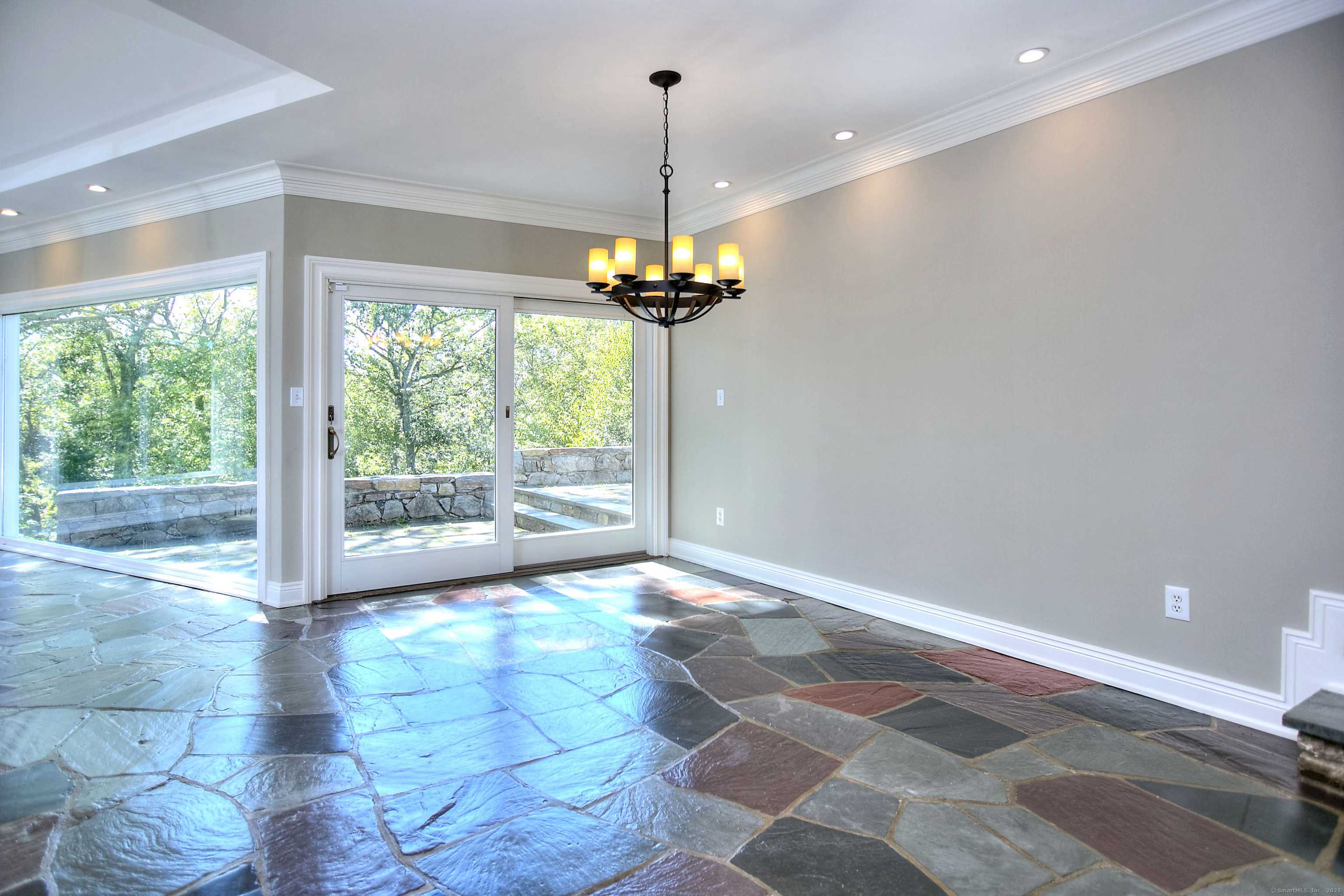 27 Rogues Ridge Road Weston, CT 06883 - Photo 15 of 39 a view of a room with a chandelier and glass door