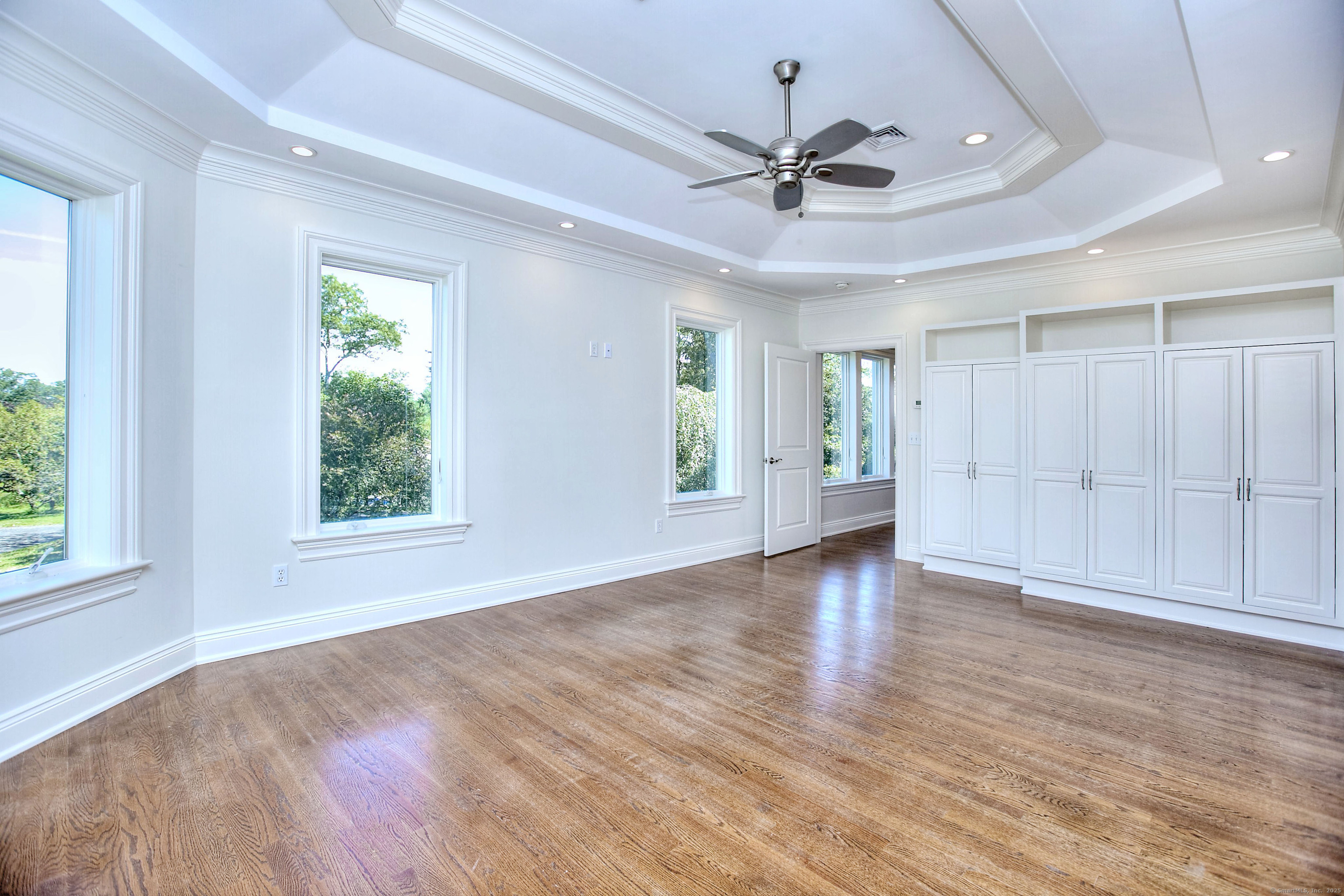 27 Rogues Ridge Road Weston, CT 06883 - Photo 18 of 39 a view of an empty room with a window and wooden floor