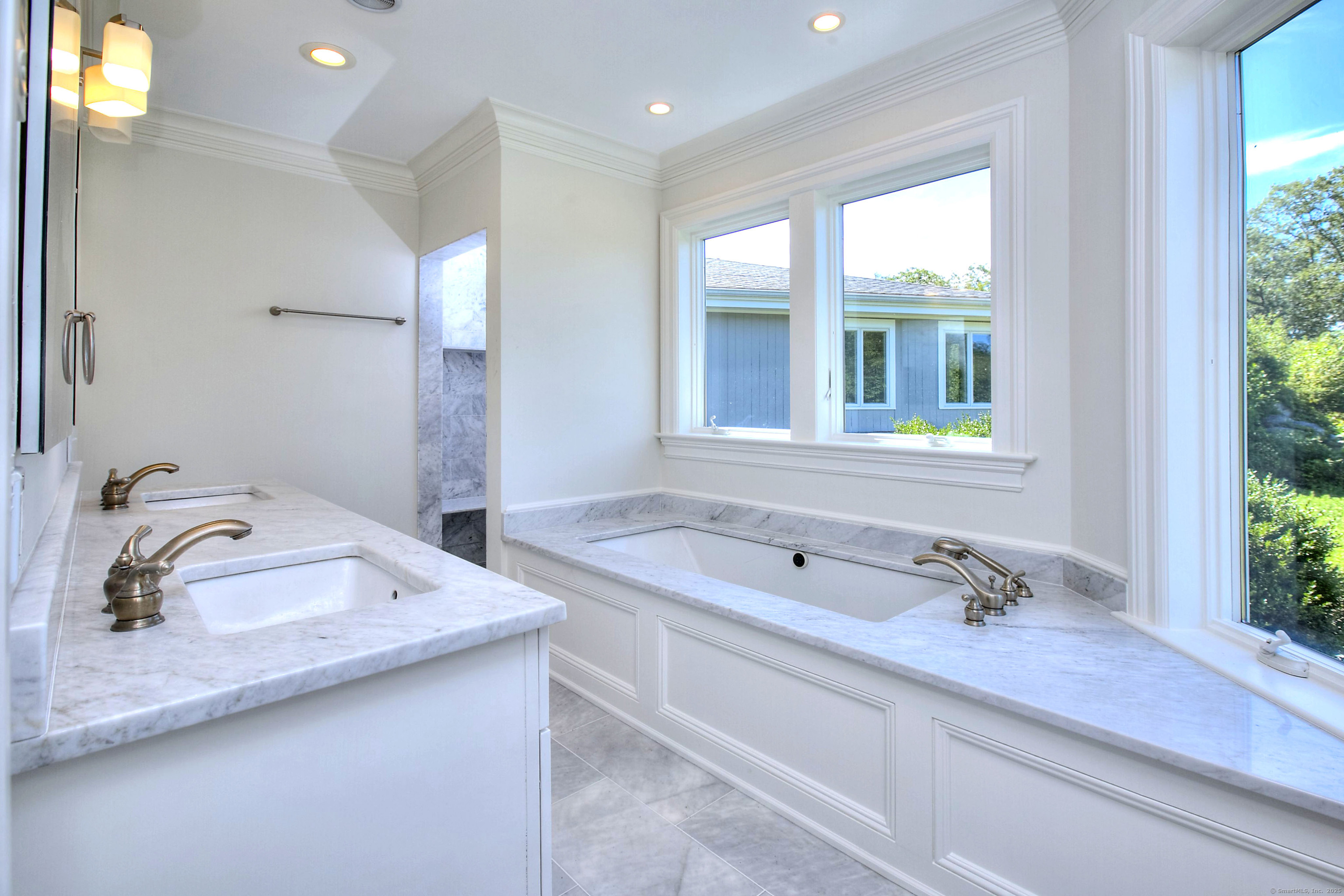 27 Rogues Ridge Road Weston, CT 06883 - Photo 19 of 39 a bathroom with a tub sink and mirror