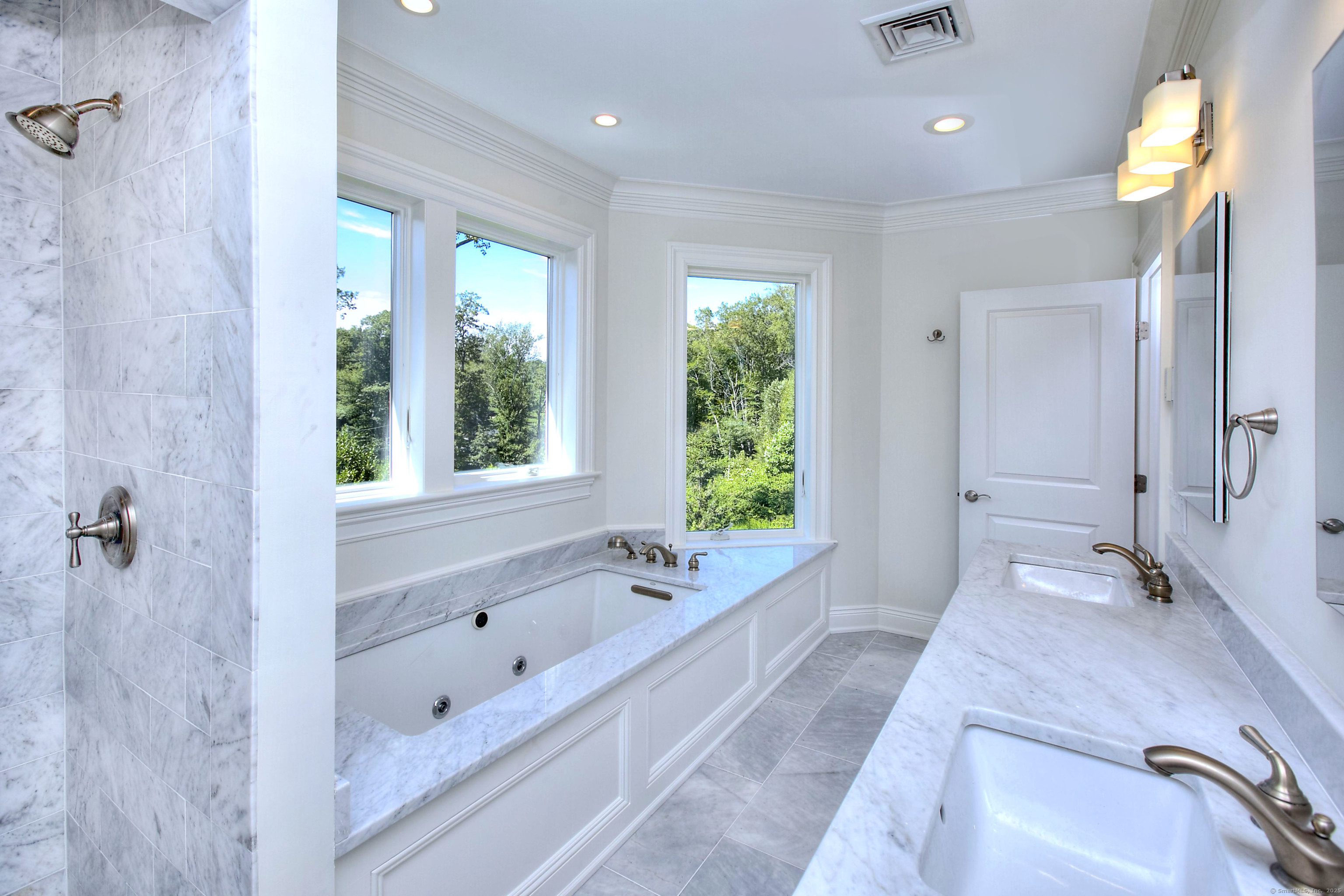 27 Rogues Ridge Road Weston, CT 06883 - Photo 20 of 39 a spacious bathroom with a granite countertop tub sink and mirror